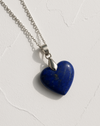 Blue heart-shaped pendant on a silver chain against a white background