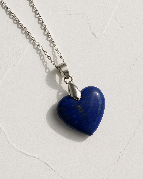 Blue heart-shaped pendant on a silver chain against a white background
