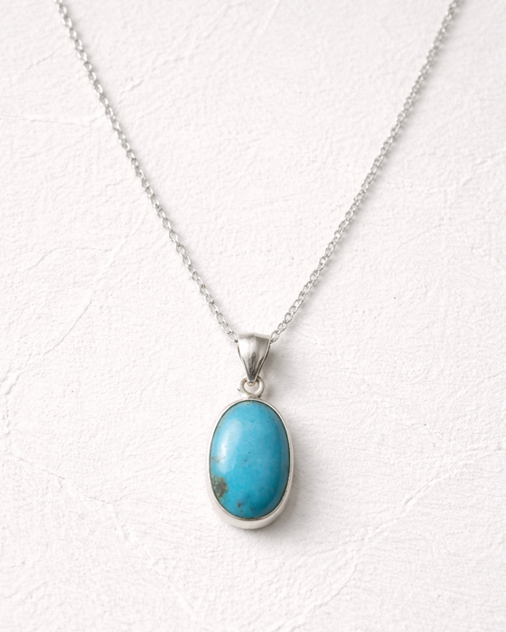 Turquoise pendant necklace on a white background