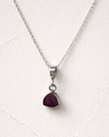 Necklace with a red gemstone pendant on a white background