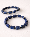 Blue beaded necklace on a white background