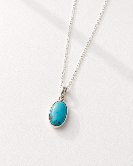 Turquoise pendant necklace on a white background