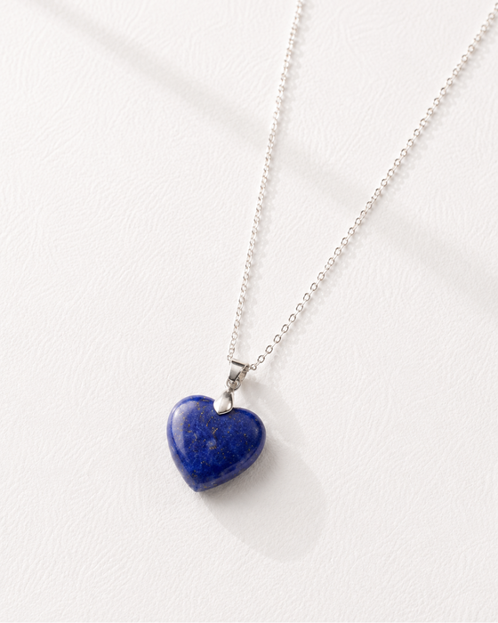Necklace with a blue heart-shaped pendant on a white background