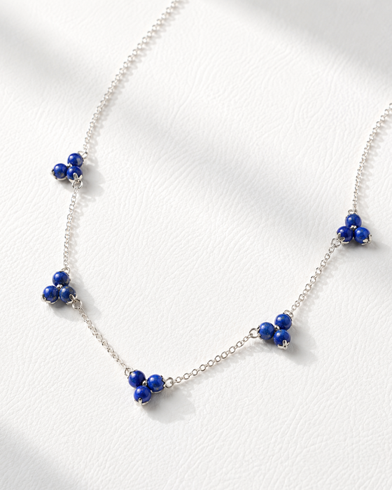 Necklace with blue beads on a white background
