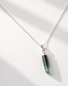 Necklace with a green pendant on a white background