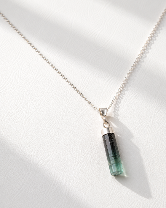 Necklace with a green pendant on a white background