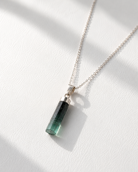 Necklace with a green pendant on a white background