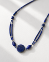 Blue beaded necklace on a white background