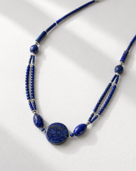 Blue beaded necklace on a white background