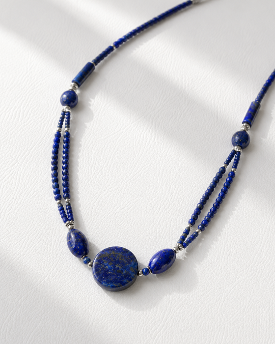 Blue beaded necklace on a white background