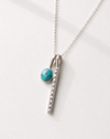 Necklace with a turquoise pendant on a white background