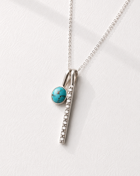 Necklace with a turquoise pendant on a white background