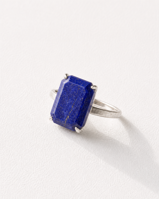 Ring with a blue gemstone on a white background