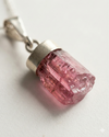 Pink crystal pendant on a white background