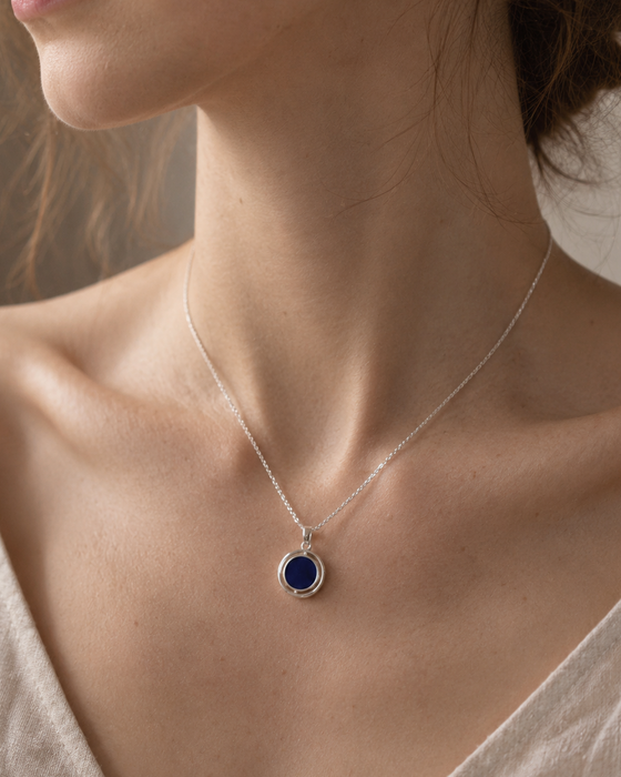 Necklace with a blue pendant worn by a person