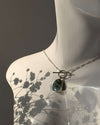 Necklace with a pendant on a mannequin against a dark background