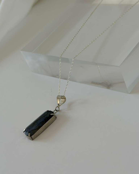 Necklace with two pendant stones on a white background