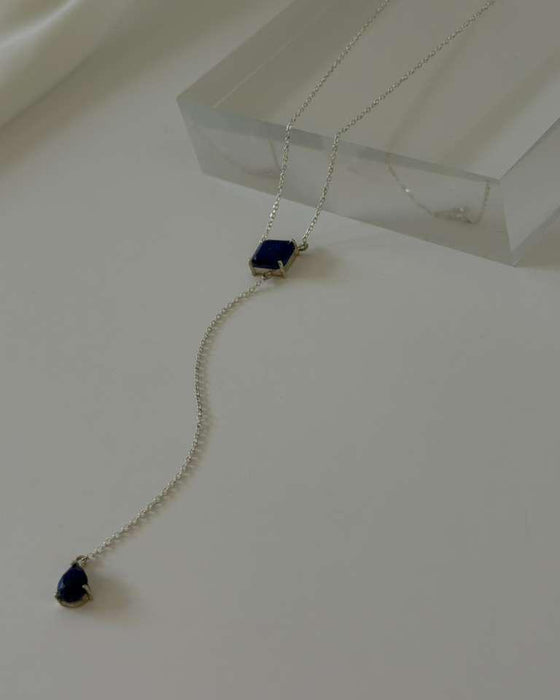Necklace with blue gemstones on a white surface