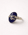 Silver ring with a blue stone on a white background