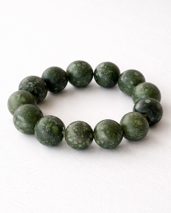 Green beaded bracelet on a white background
