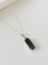 Necklace with a black pendant on a white background