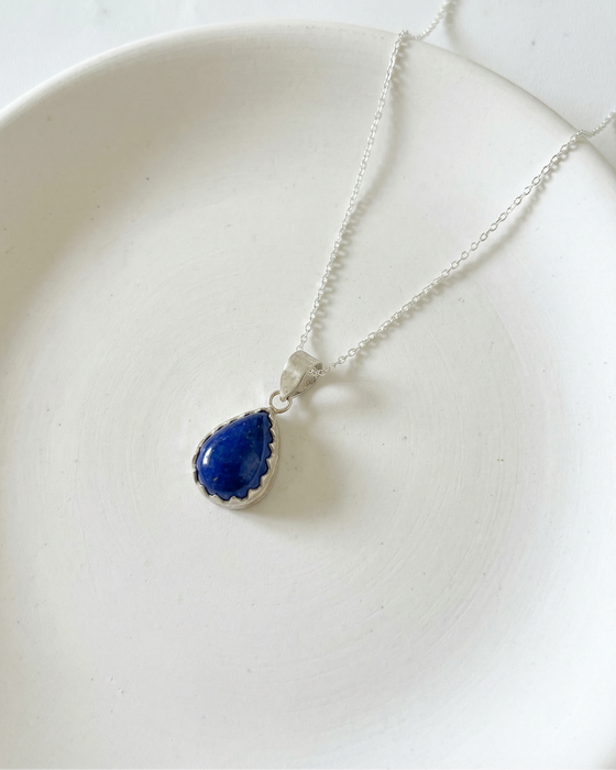 Necklace with a blue pendant on a white background
