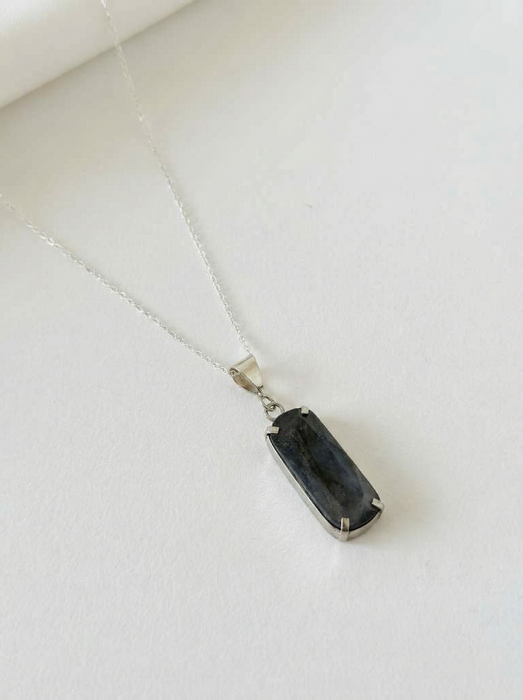 Necklace with a black pendant on a white background