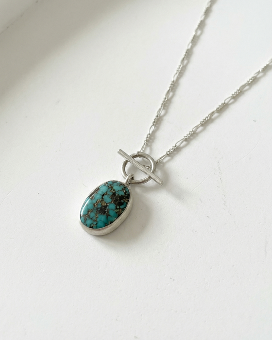 Turquoise pendant necklace on a white background